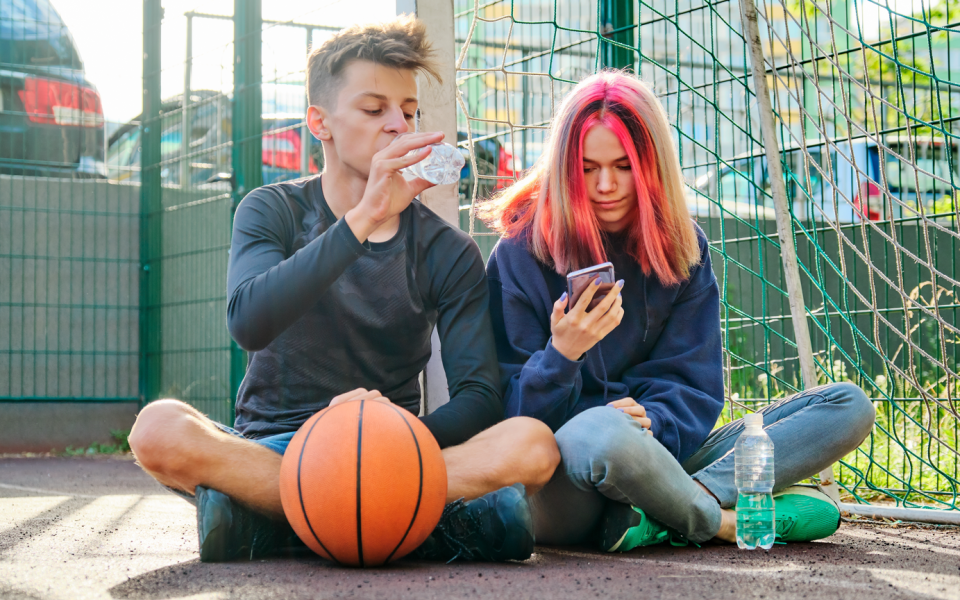 Twee jongeren op pleintje met basketbal