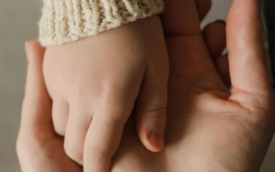 kinder-hand-op-handen-ouder