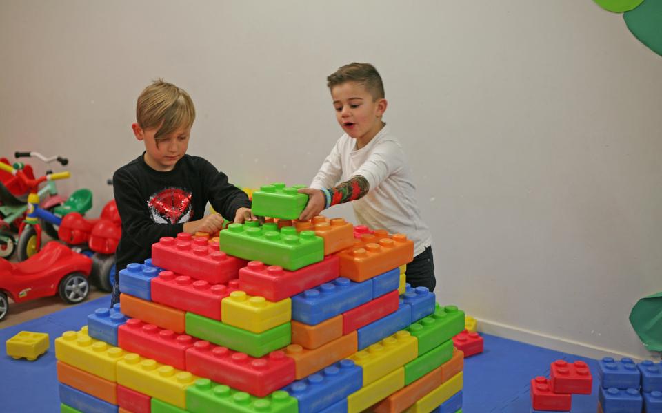 2 kinderen spelen met grote blokken