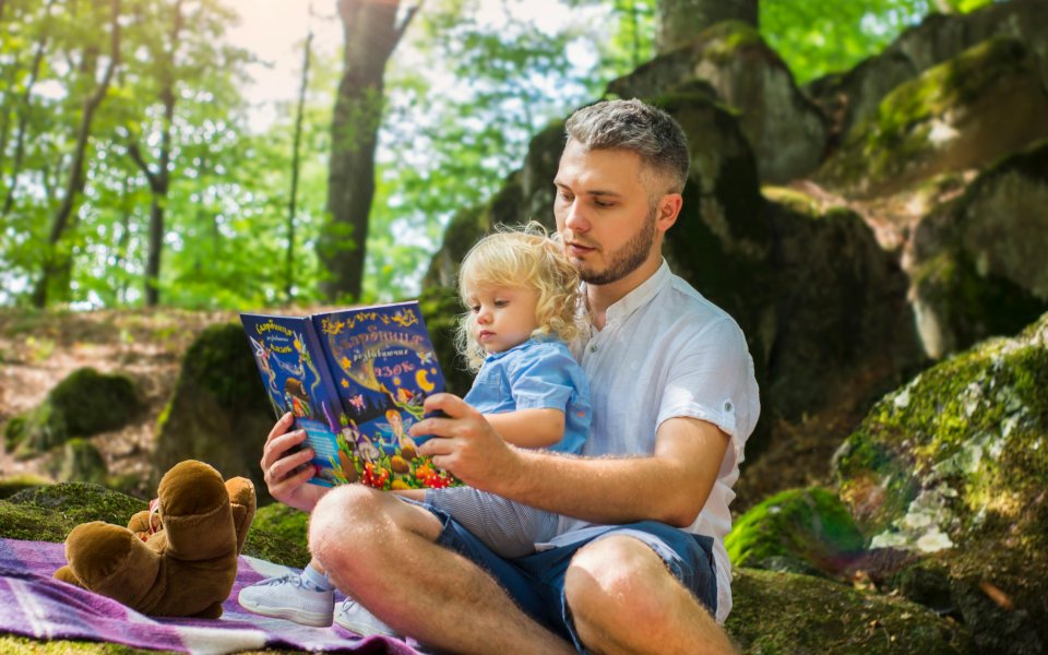 vader leest voor in het bos